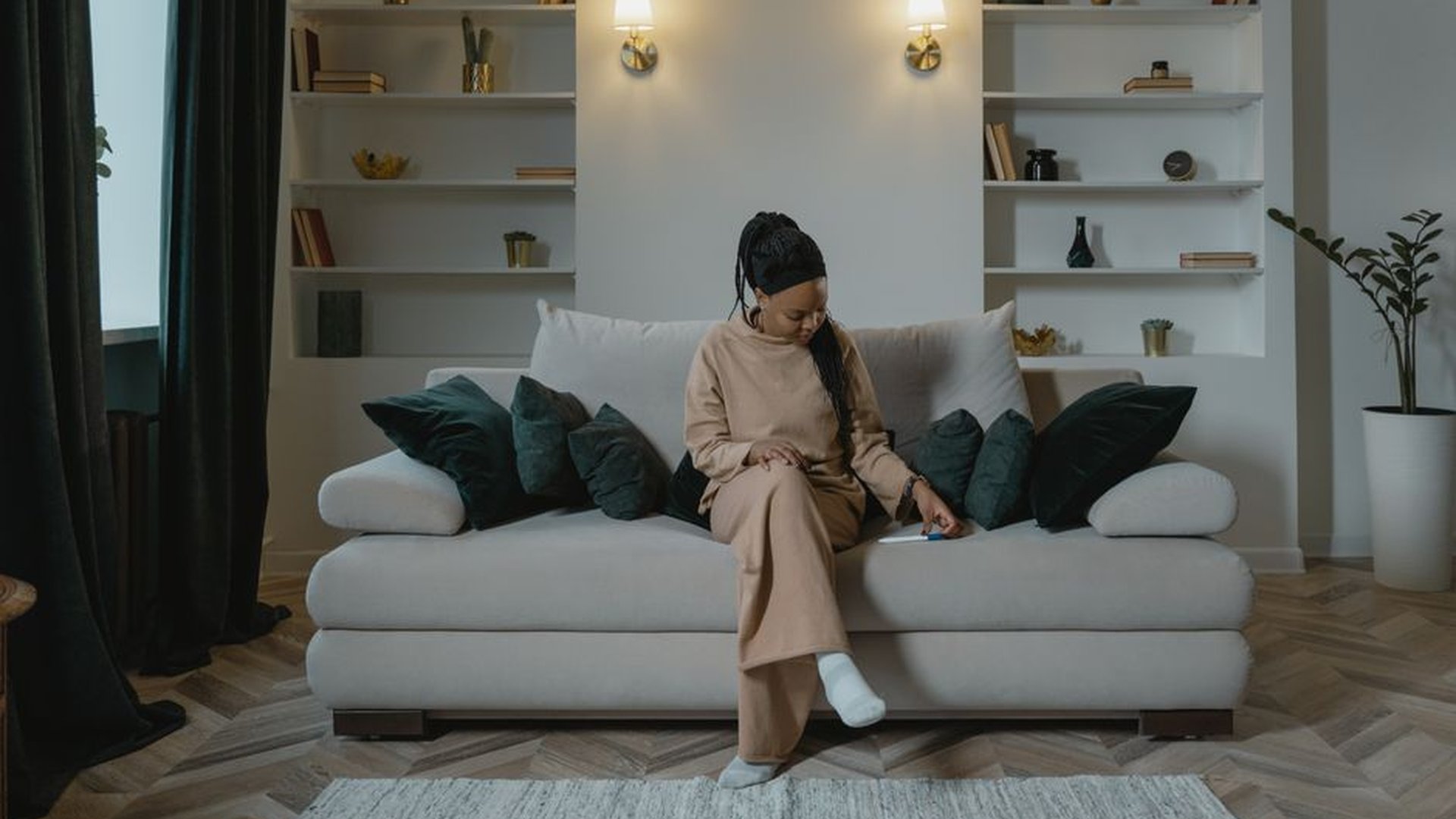 person sitting sofa testing seat depth back suppor
